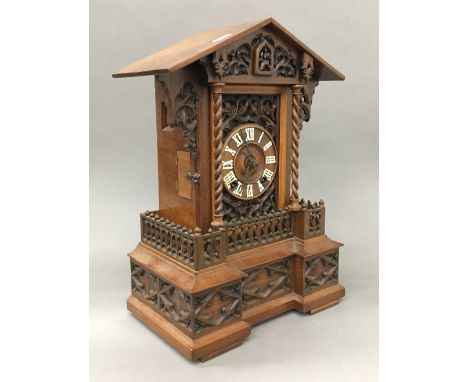 A 19th century carved walnut cuckoo clock