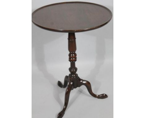 A George III mahogany snap top tripod supper table, the shallow dish top raised on a part bobbin turned stem with triple cabr