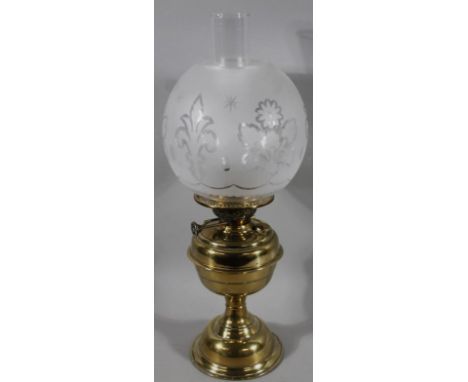 An early 20thC brass oil lamp, with part frosted glass, florally decorated globular shade, plain funnel and shaped column, 52