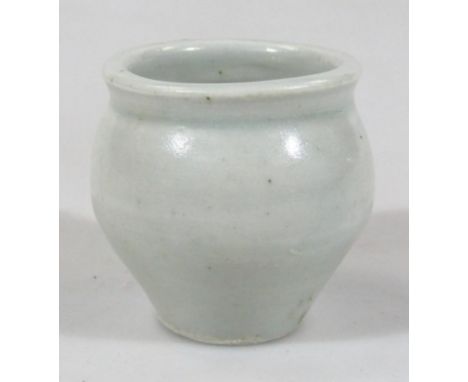 A Bernard Leach Studio pottery bowl, of small proportion, with a circular bellied body, in cream glazes, on circular foot, ma