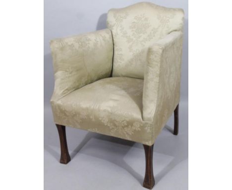 A late 19thC oak framed armchair, with upholstered comb back arms and deep seat, on shaped supports, in floral material, 89cm