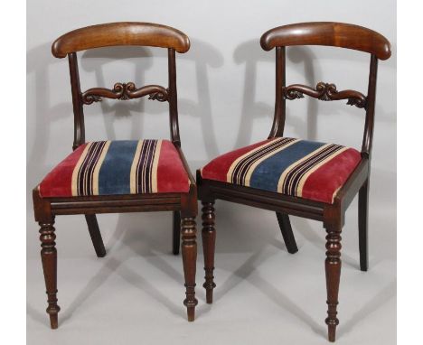 A pair of early Victorian mahogany dining chairs, with inverted comb tops above scroll horizontal splats and drop-in seats in
