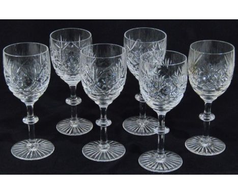 A set of six crystal wine glasses, with part hobnail cut bell shaped bowls, on tapering and compressed circular stems with st