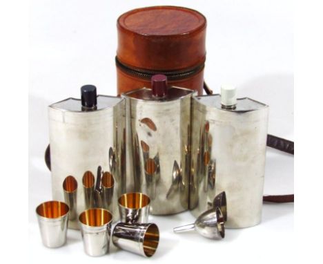An Art Deco chrome plated travelling decanter set, in a cylindrical leather case with strap handle with three 'C' shaped deca