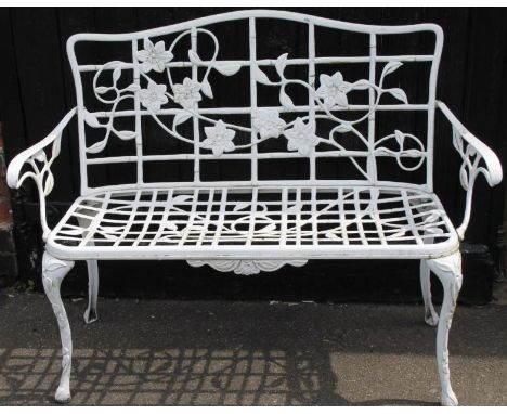 A modern cast metal garden bench, of pierced floral outline, with D-end seat on cabriole supports with naturalistic scroll ar