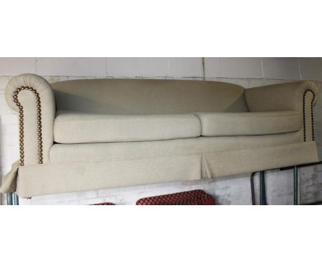 A modern Chesterfield settee, in light material, partially studded, 68cm high, 212cm wide, 94cm deep.