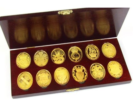 A cased set of twelve sterling silver 22ct gold plated Prince and Princess of Wales limited edition ingots, in polished woode