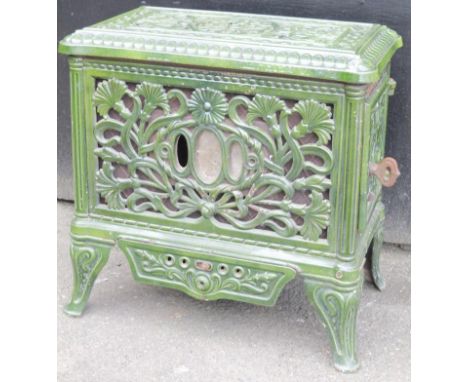 A 1920's Art Nouveau green enamel cast iron Scott stove, the shaped rectangular top with an outer banding partially pierced w