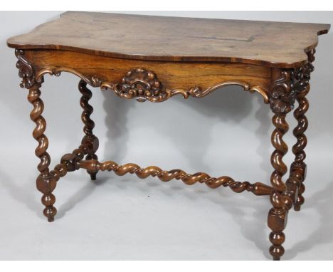An early Victorian rosewood serpentine side table, the shaped top raised above a heavily carved apron with scrolls and flower