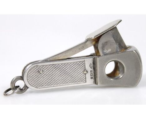 An Elizabeth II silver cigar cutter, part engine turned with articulated side, Birmingham 1973, 7cm high.