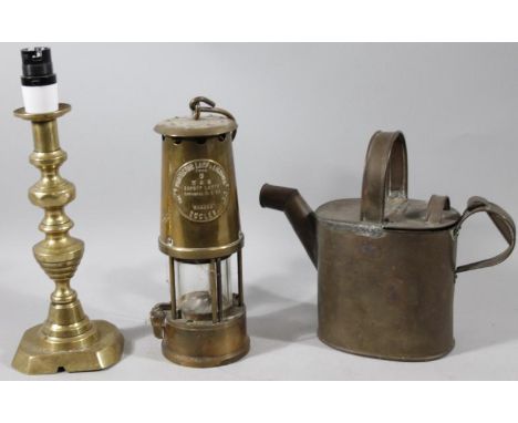 A 20thC brass Eccles protector miner's lamp, no.6 and raised with the initials M & Q, with swing handle and partial glass bod