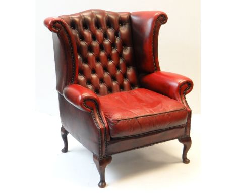 VINTAGE RED LEATHER BUTTON UPHOLSTERED WING BACK ARMCHAIRThere is a fair bit of general wear, scratches to the arms, the top 