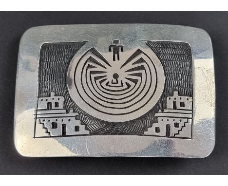 An Aztec style belt buckle, stamped 'Suzi Sterling 950 Silver', 8 x 5.5cm wide. 