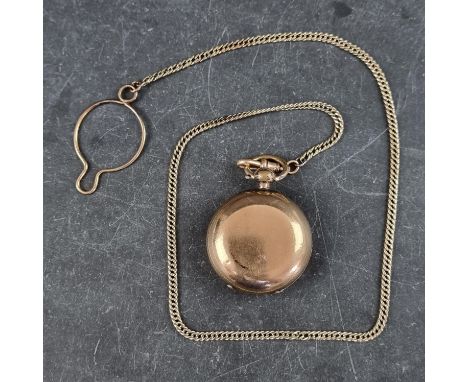 A late 19th/early 20th century gold plated sovereign case, 34mm diameter, by Dennison, on a chain, 42cm. 