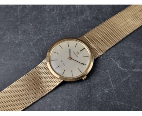 A vintage Omega 'De Ville' 9ct gold manual wind wristwatch, 33mm, on 9ct gold Omega Milanese bracelet. 