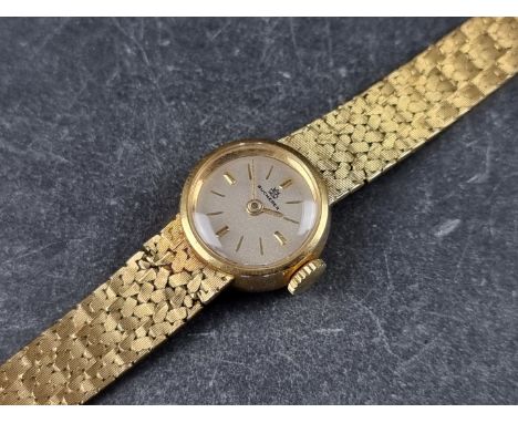 A vintage Bucherer yellow metal manual wind ladies wristwatch, 17mm, stamped 18k, on original integrated bracelet. 
