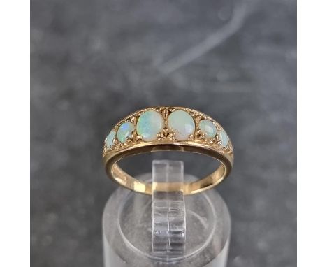 A 9ct gold opal six stone gypsy ring, size L, gross weight 2.4g. 