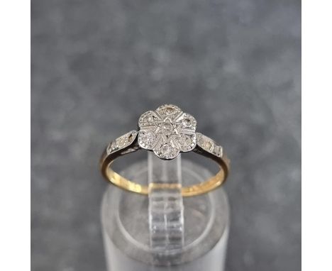 A 18ct gold and platinum diamond daisy ring, size K 1/2, gross weight 2.3g. 