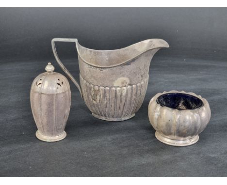 A pair of silver pepperettes, by Garrard &amp; Co Ltd, Birmingham 1957; together with a silver milk jug, height to handle 9cm