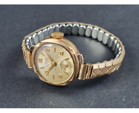 A vintage Avia 9ct gold manual wind ladies wristwatch, 21mm, on gold plated expanding bracelet. 