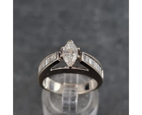 A marquise diamond ring, with eighteen diamonds to shoulders, stamped '18ct', size M. 