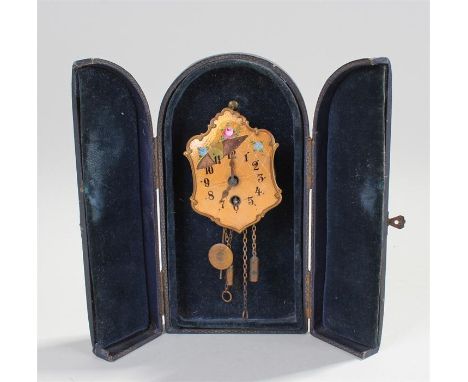 Miniature enamel clock, Germany. The orange enamel clock in the form of a hanging wall clock, with pendulum and weights, the 