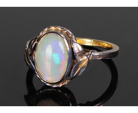 Yellow metal opal set ring, the central opal with leaf shoulders, ring size Q 1/2