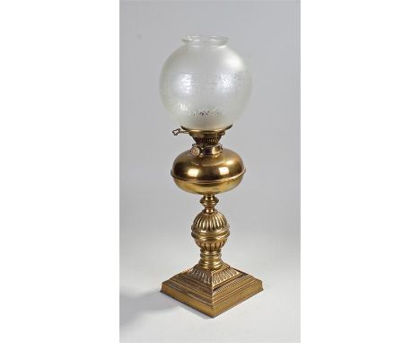 Frosted glass and brass oil lamp, the foliate frosted glass shade above a brass reservoir and fluted bulbous column, stepped 