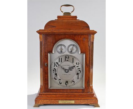 George III style oak cased bracket clock, W.H. Skinner, St Leonards on Sea. The pad top with brass swing handle, canted reede