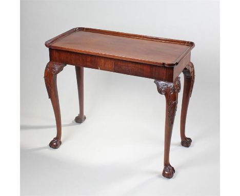 George III mahogany silver table, the rectangular top wish dish edge, raised on acanthus leaf cabriole legs, converted from a