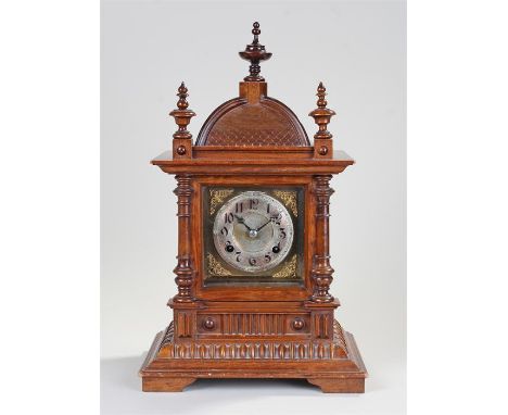 Late Victorian walnut mantel clock, the pagoda top above turned columns and reeded stepped base, the silver chapter ring with