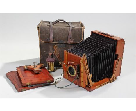Early 20th Century The Sanderson mahogany plate camera, together with a J Taylor Optician Nottingham lens, canvas bag and two
