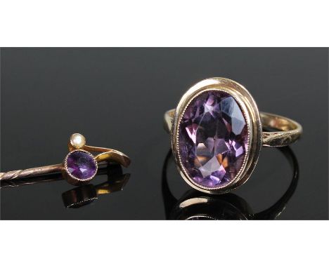 20th Century amethyst and 9ct gold dress ring, the oval facet cut stone within a millegrain setting on pierced shoulders, tog