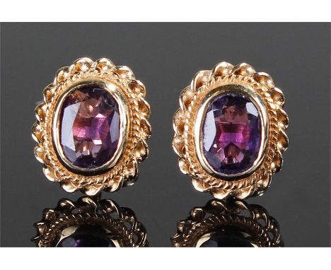 Pair of 9 carat gold and amethyst earrings with a rope twist border, 12mm high