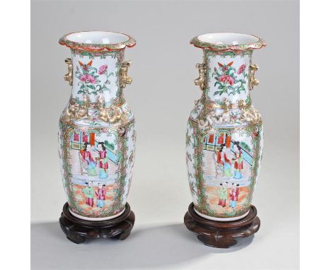Pair of late 19th Century Chinese Canton vases, polychrome painted with Chinese figural scenes, foliate scroll boarders, 27cm