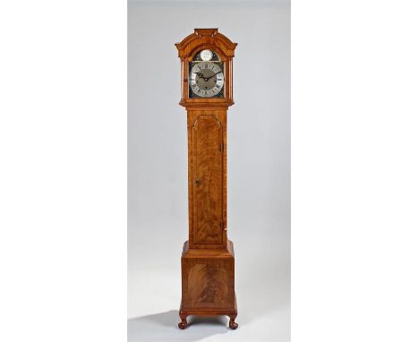 Walnut longcase clock of small proportions. The arched hood with glazed door, long trunk door with plinth base raised on cabr