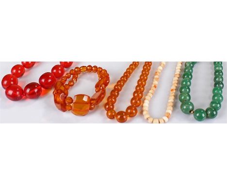 Chinese spinach jade necklace, graduating spheres, together with a coral bead necklace, a bakelite amber necklace and an ambe