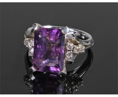 White metal amethyst and diamond ring, the central  baguette cut amethyst flanked by eight diamonds, ring size N