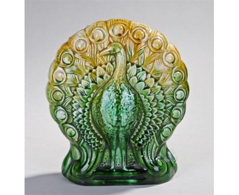 Ault Pottery green glazed Peacock Vase after a design by a Christopher Dresser, with holes in the top and a peacock and a rel