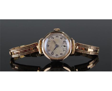 9 carat gold wristwatch with a silvered dial, Swiss movement, manual wound, case 25mm diameter 