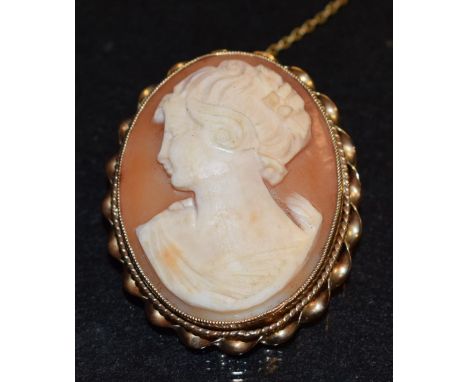 A 9ct gold mounted oval shell cameo brooch, portrait profile of a Maiden, JCY & Co, 9ct gold bead and rope twist frame, Birmi