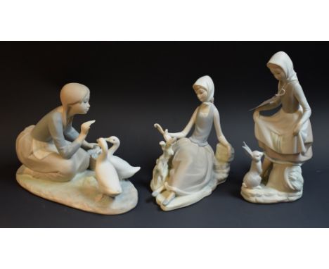 A Lladro figure group, Food For Ducks, matte finish; others, Shepherdess With Dove, Rabbit's Food (3)