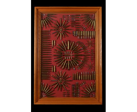 A MODERN FRAMED AND GLAZED AMMUNITION DISPLAY BOARD,displaying calibres, from 3mm to .600 nitro-express, including pinfire an