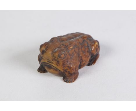 A JAPANESE WELL CARVED BOXWOOD NETSUKE OF A TOAD, signed with two characters 