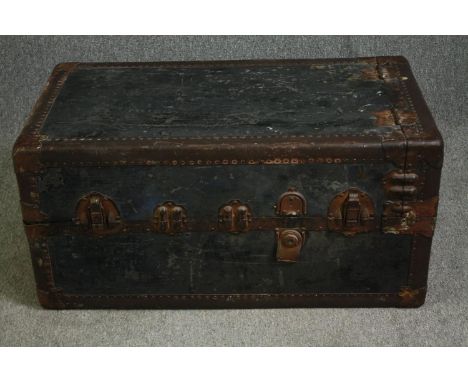 A vintage travelling trunk with lined floral decorated fitted interior. H.103 W.52 D.57cm. (Upright)