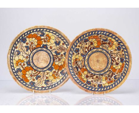 Charlotte Rhead (1885-1947) for Crown Ducal two pottery chargers decorated with orange and blue flowers, each signed to the r