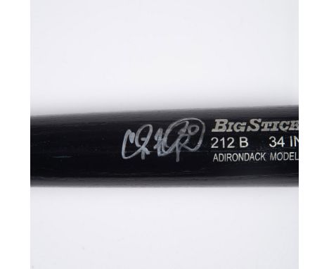 This is a black Big Stick #212B Adirondack model baseball bat signed in silver by Cliff Floyd. Dimensions: 34"L x 8"Cir. Manu