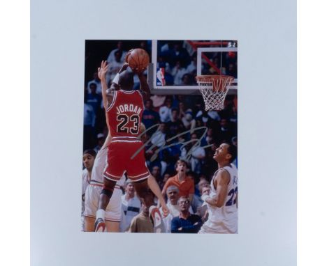 Game photo of basketball GOAT Michael Jordan signed in silver permanent ink. Certificate of Authenticity included from Worldw