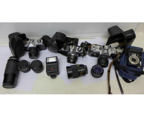 Cameras and equipment, three 35mm film cameras and five spare lenses, Pentax ME Super with 50mm lens and one other spare lens