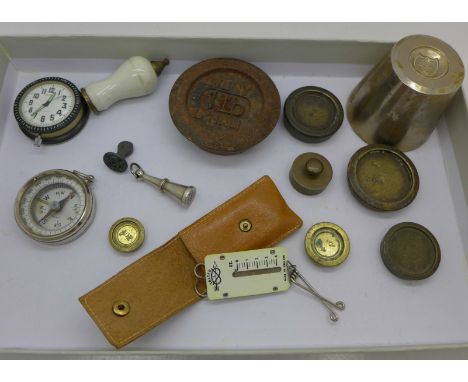 A collection of weights, seals, a compass and a clock
